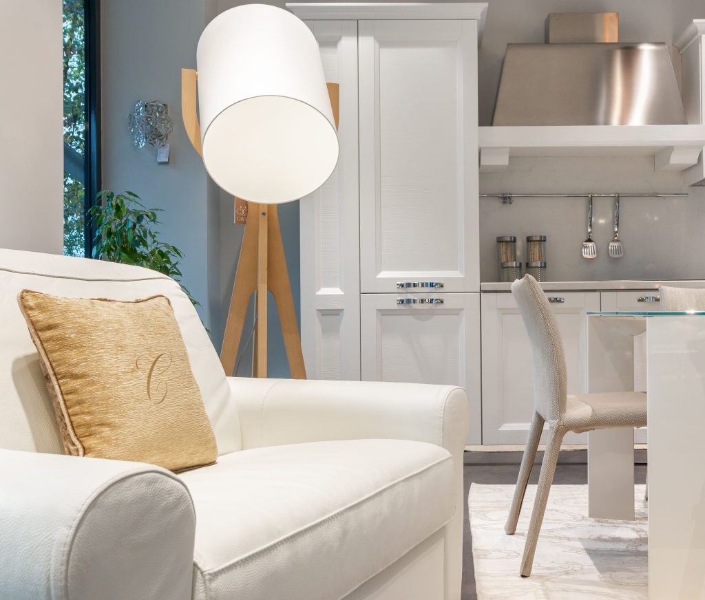 pexels-photo-7535065-7535065 Creative lamp placed near soft armchair in spacious studio apartment with dining table in light kitchen zone